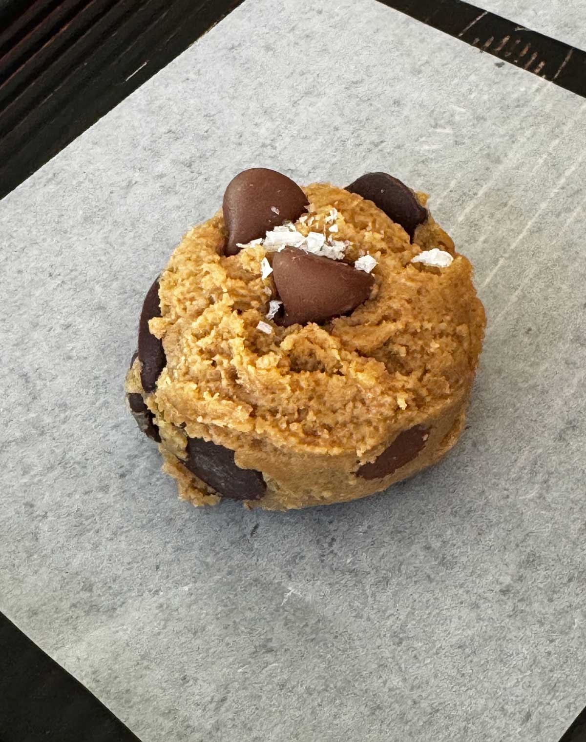 Scooped ball of malted chocolate chip cookie dough.