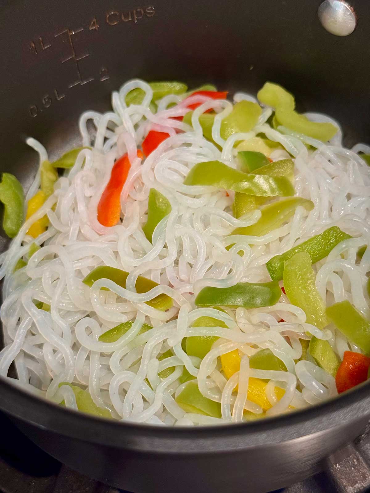 Miracle Noodles, a good tasting brand of Shirataki noodles, being dry cooked in a saucepan.