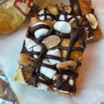 Kraft Caramel Crunch Bars recipe with a layer of graham crackers, melted Kraft caramel bits, marshmallows, peanuts, pretzels and chocolate.