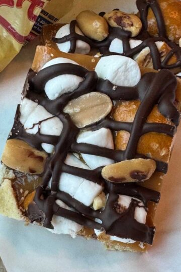 Kraft Caramel Crunch Bars recipe with a layer of graham crackers, melted Kraft caramel bits, marshmallows, peanuts, pretzels and chocolate.