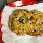 Small Batch Oatmeal Raisin Cookies on a parchment lined plate showing thickness.