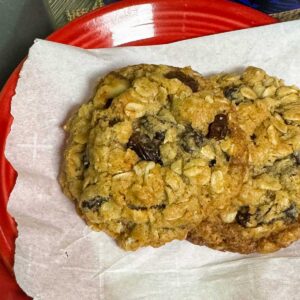 Small Batch Oatmeal Raisin Cookies on a parchment lined plate showing thickness.