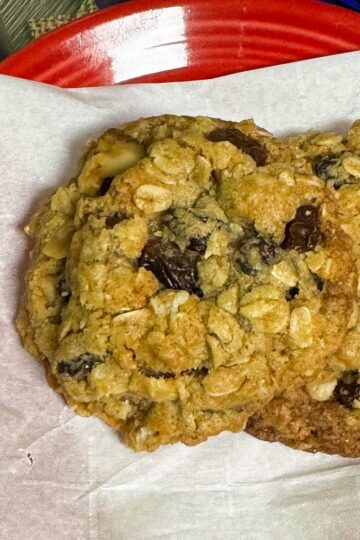 Small Batch Oatmeal Raisin Cookies on a parchment lined plate showing thickness.