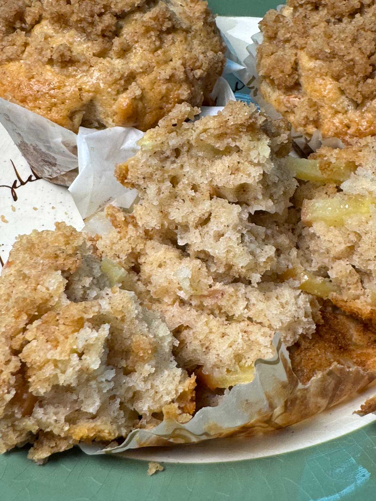 Streusel Apple-Oat Muffins with a Moist Crumb split to show texture.