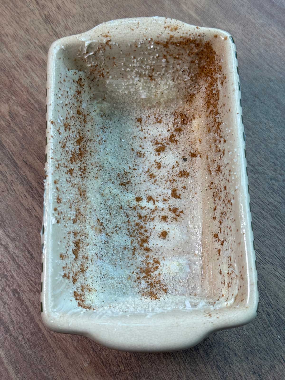 Mini loaf pan greased with butter, coconut oil, cinnamon and sugar.