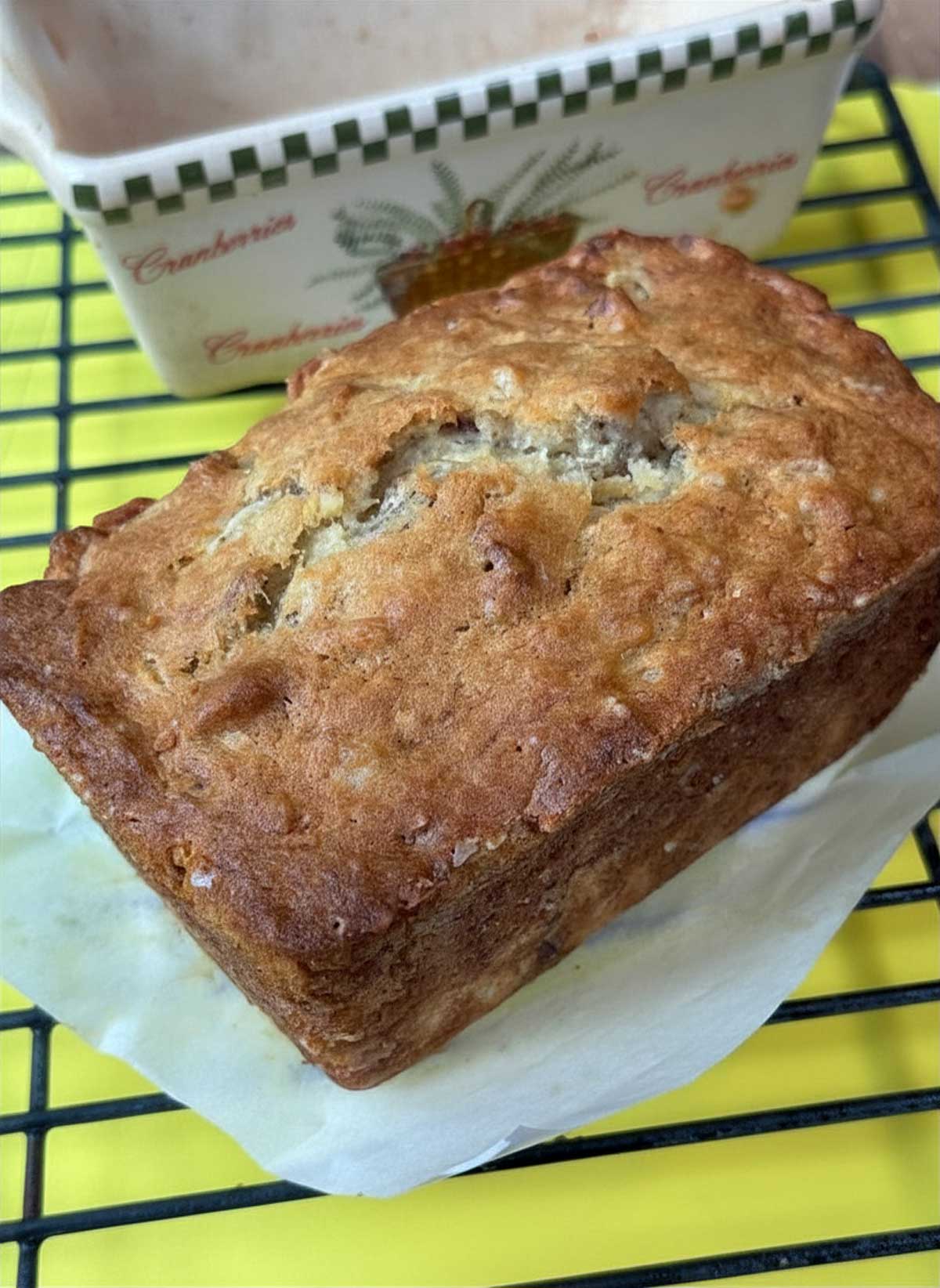 Tropical Banana Bread recipe baked in a ceramic loaf pan.