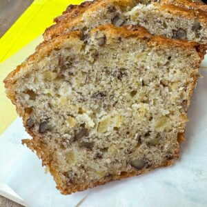 ropical Banana Bread from The Hill Country Reporter sliced to show moist texture and pecans.