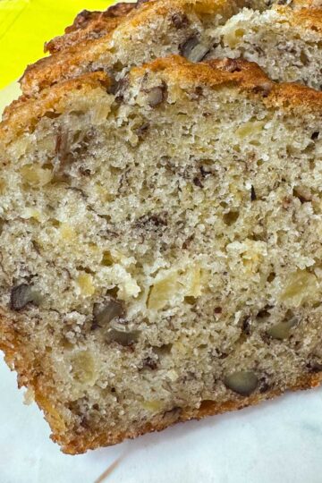 ropical Banana Bread from The Hill Country Reporter sliced to show moist texture and pecans.