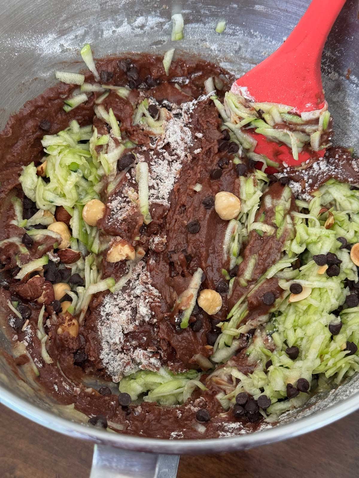 Chocolate Zucchini Cake batter in a bowl being mixed.