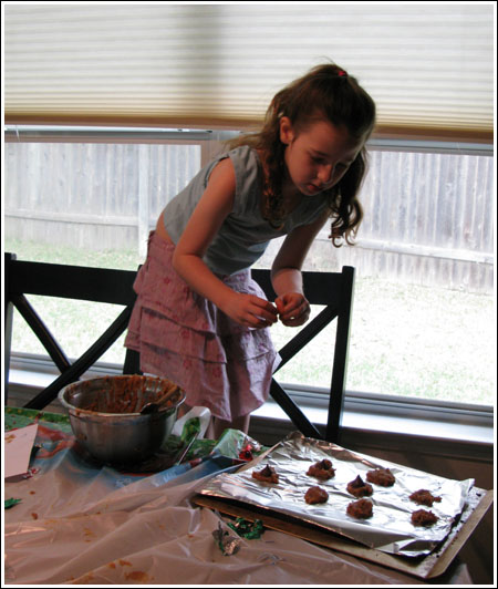 Fuzz putting Kisses on cookies.