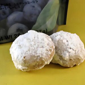 Blueberry Pecan Mexican Wedding Cookies are crumbly, light, powdered sugar coated balls with bits of dried blueberry and toasted pecans.