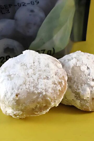 Blueberry Pecan Mexican Wedding Cookies are crumbly, light, powdered sugar coated balls with bits of dried blueberry and toasted pecans.