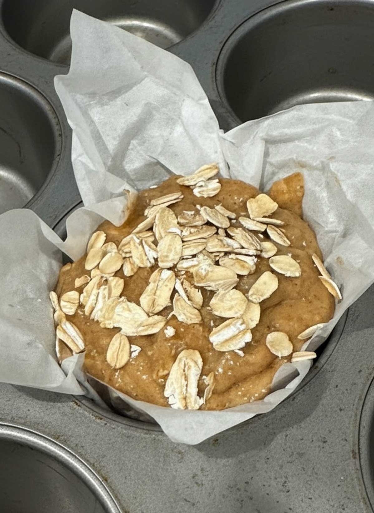 Unbaked bran muffin batter in parchment paper.