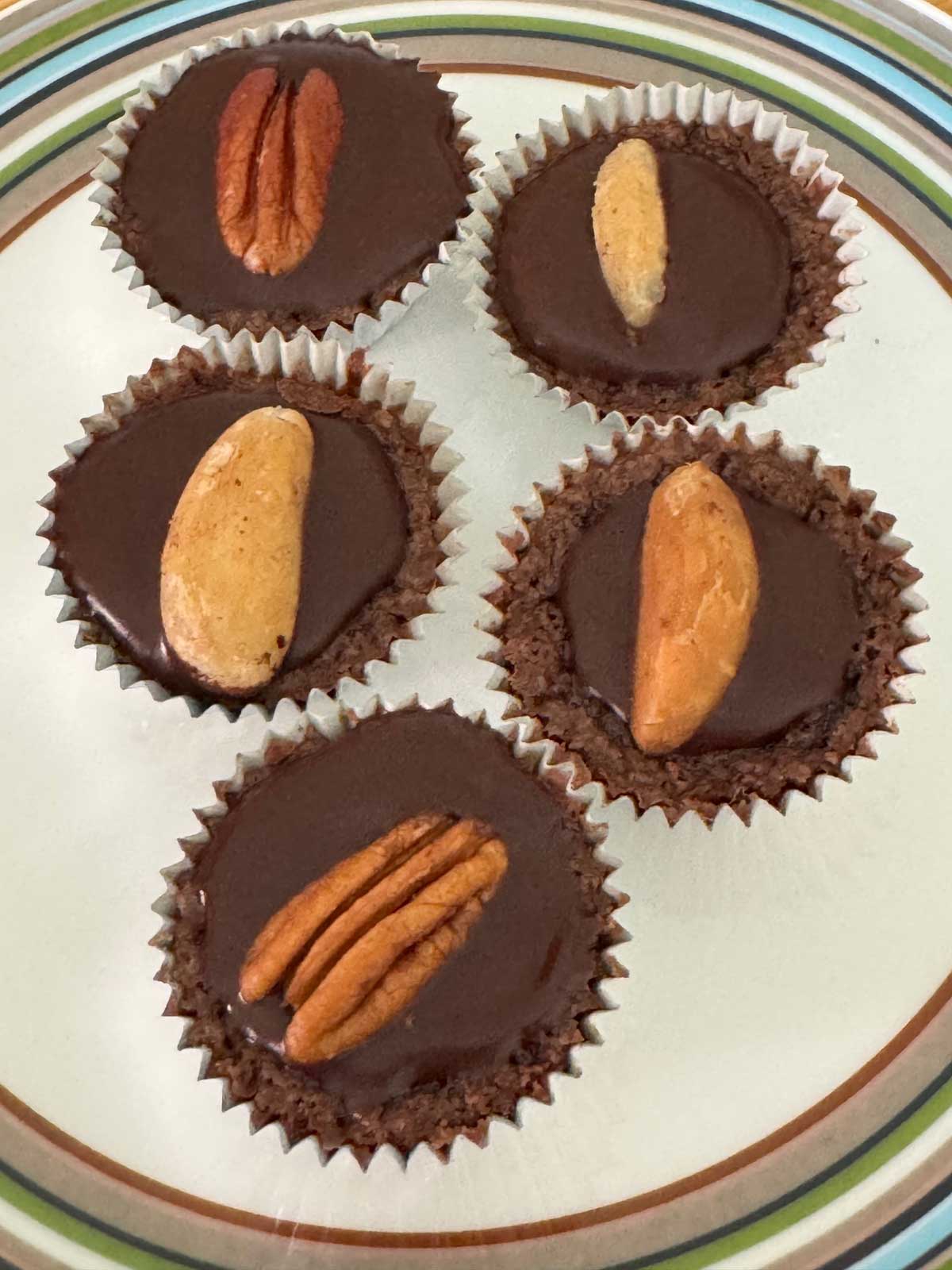 Espresso Fudge Cups with Kahlua Glaze topped with pecan halves and Brazil nuts