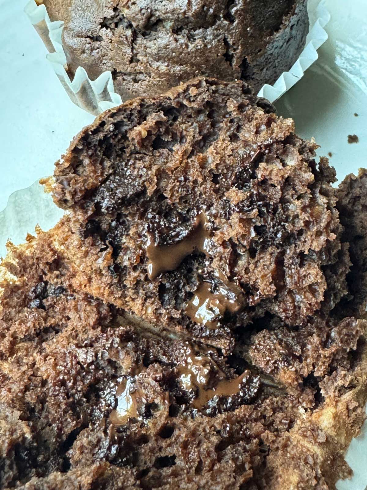 A chocolate muffin with no eggs recipe, split to show texture.