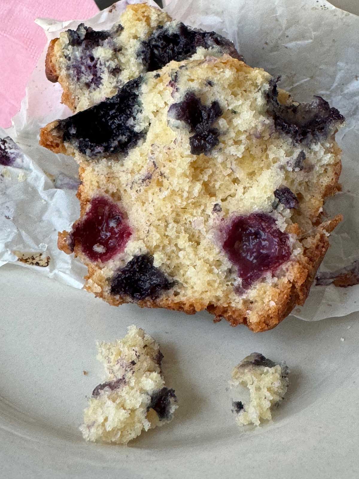 A blueberry muffin split open to show moist crumb.