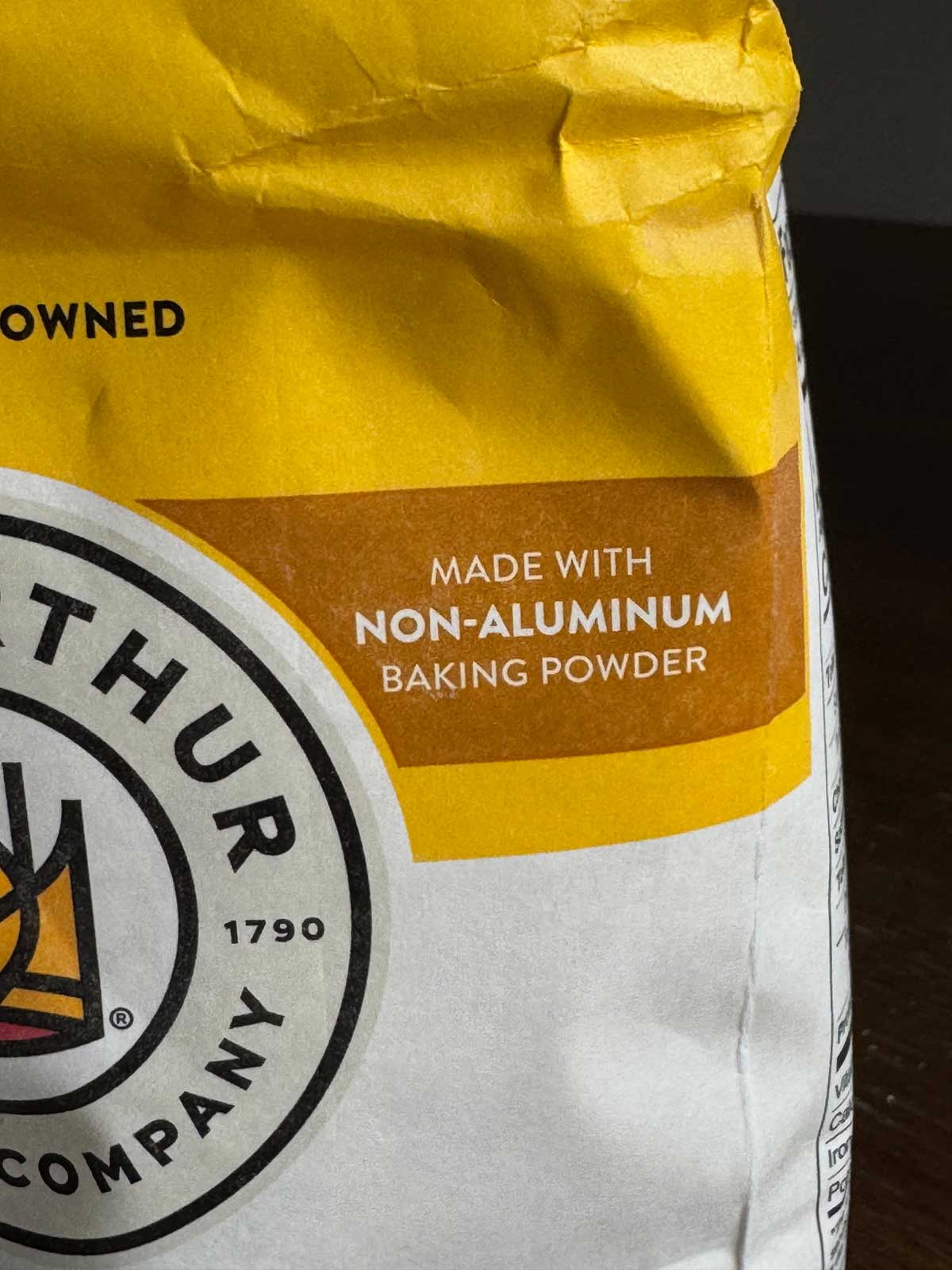 King Arthur Self-Rising Flour is unbleached and does not contain aluminum, therefore biscuits do not have that metallic taste.