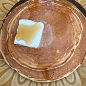 Malted Milk Pancakes on a plate with butter and syrup