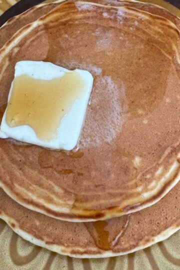 Malted Milk Pancakes on a plate with butter and syrup