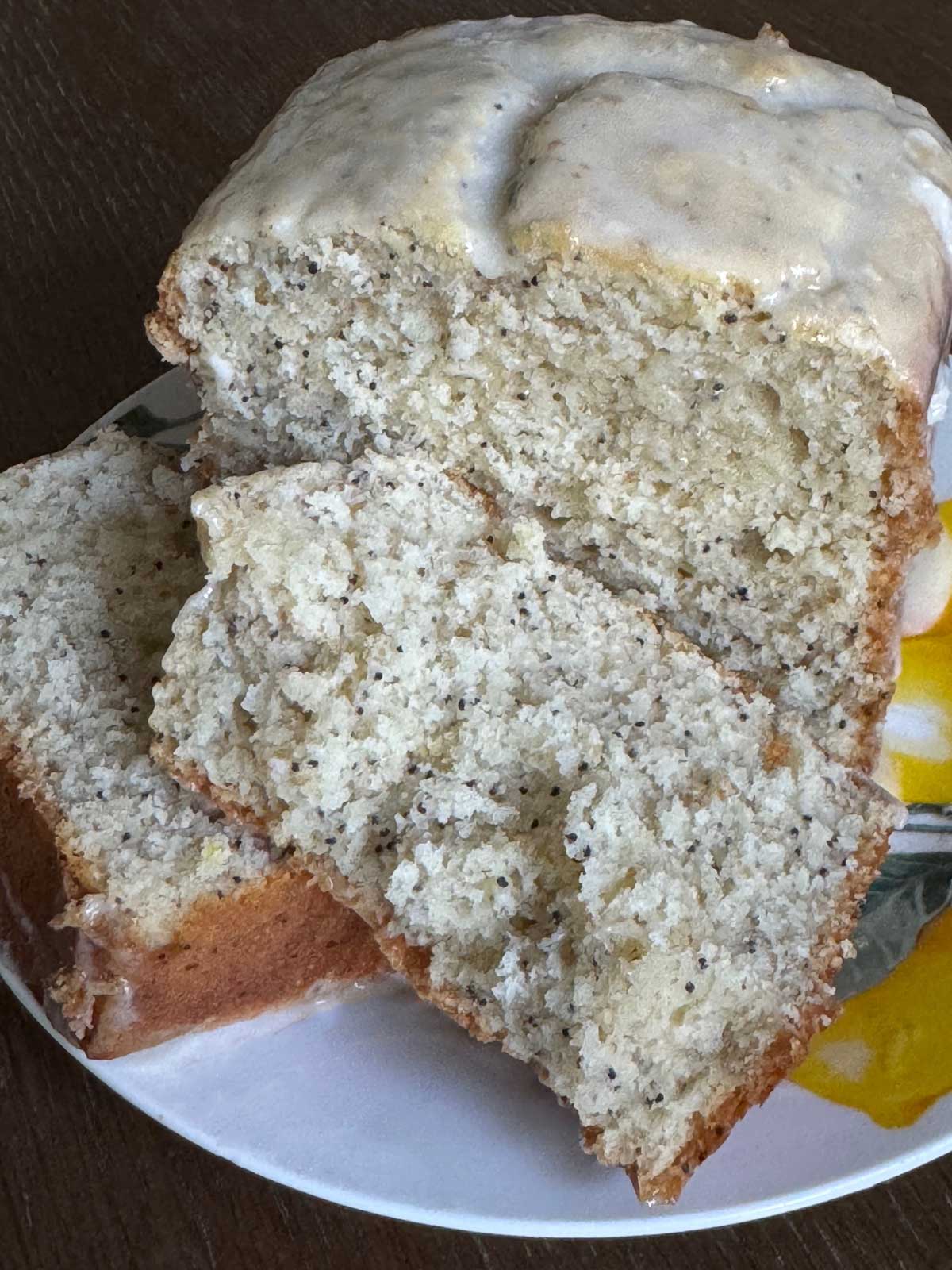 Whole Wheat Lemon Poppy Seed Bread with Lemon Icing sliced to show texture.