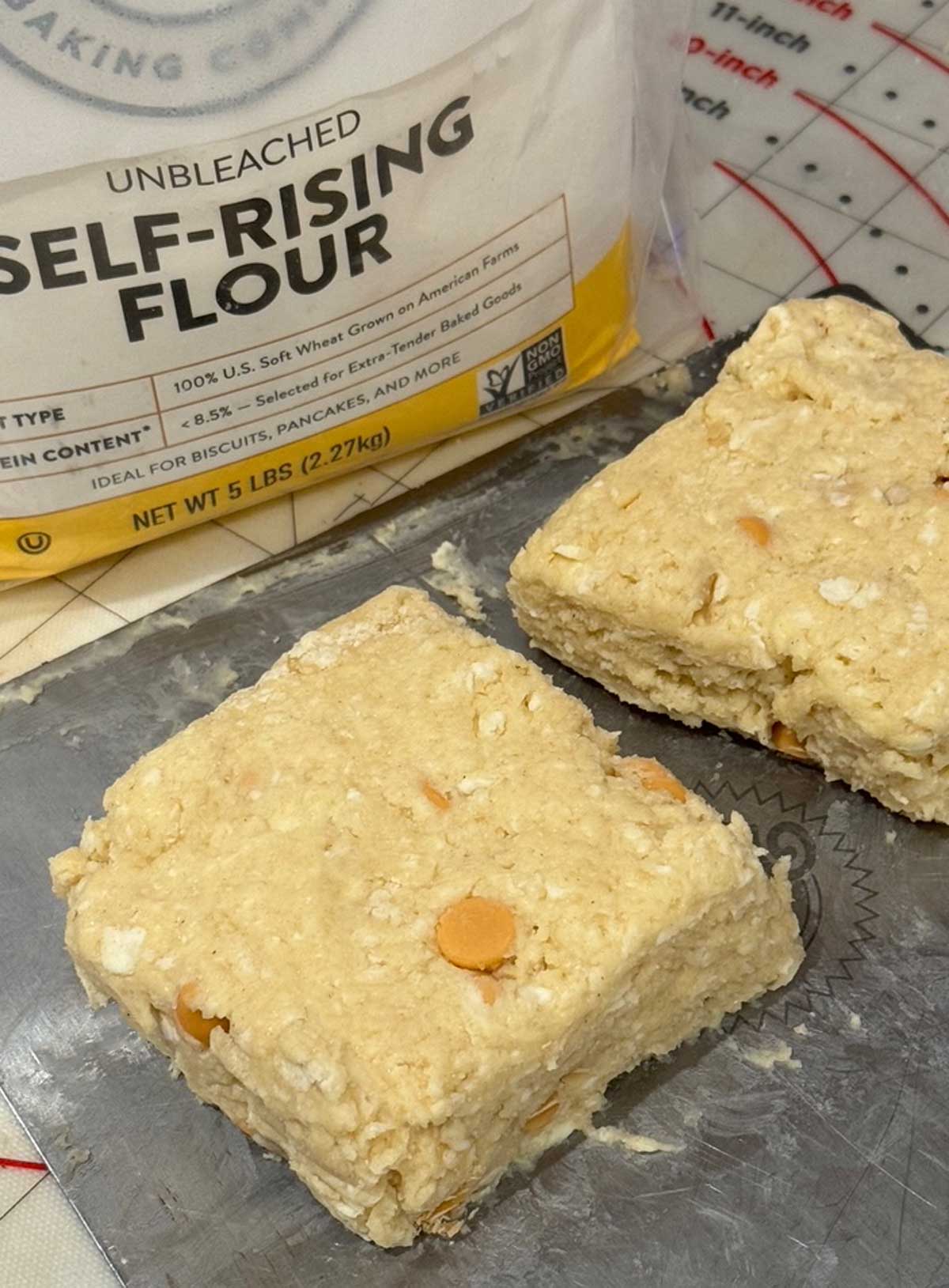 King Arthur Self-Rising Flour Cinnamon Chip Scones being cut into triangles.