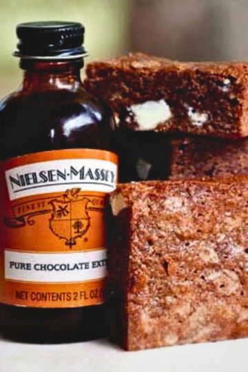 Nielsen Massey Chocolate Extract next to a stack of their Not So Blonde Brownies