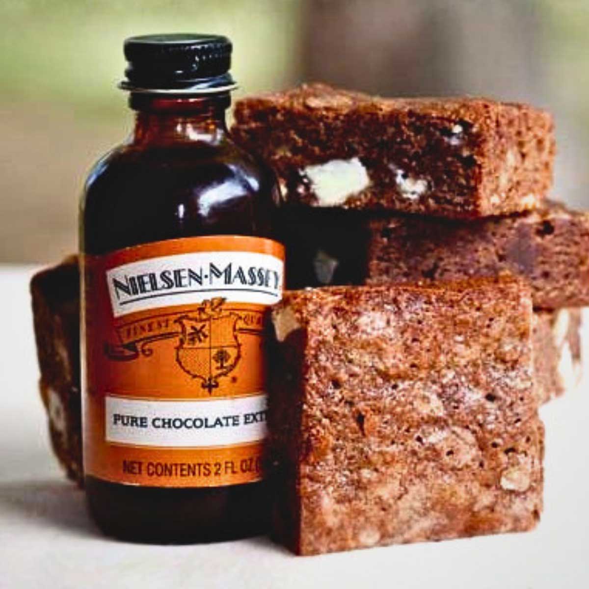 Nielsen Massey Chocolate Extract next to a stack of their Not So Blonde Brownies