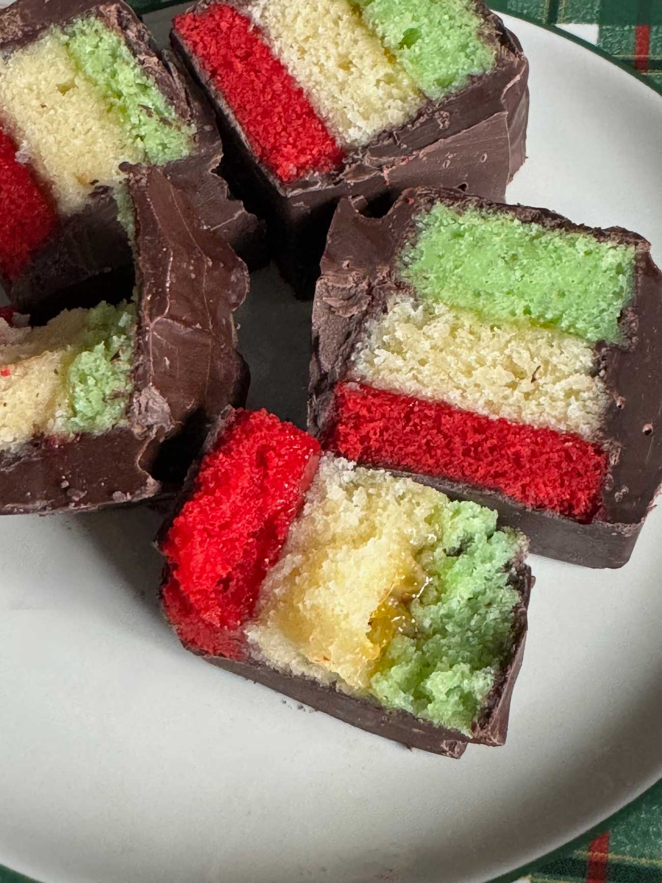 Rainbow Cookies made with almond flour and dipped in mini loaf pans filled with chocolate.