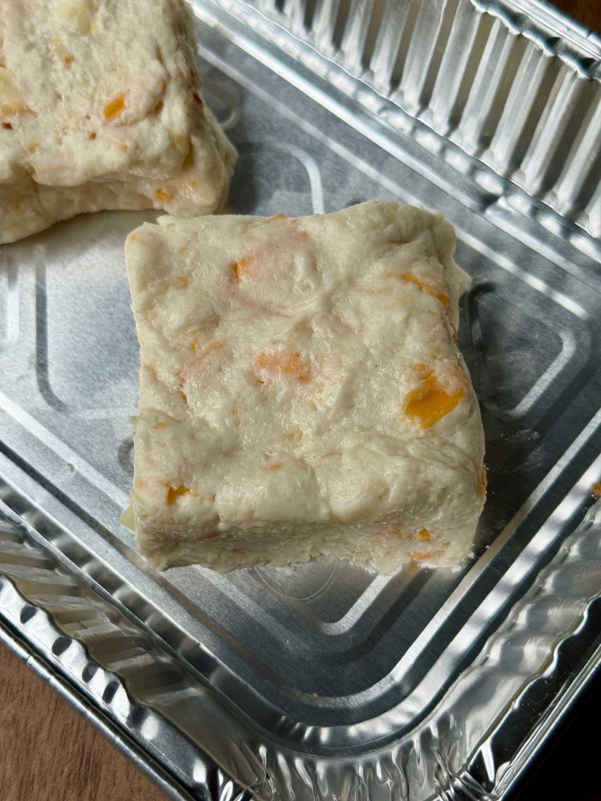 Cheddar Cheese Biscuits dough cut into squares ready to bake.