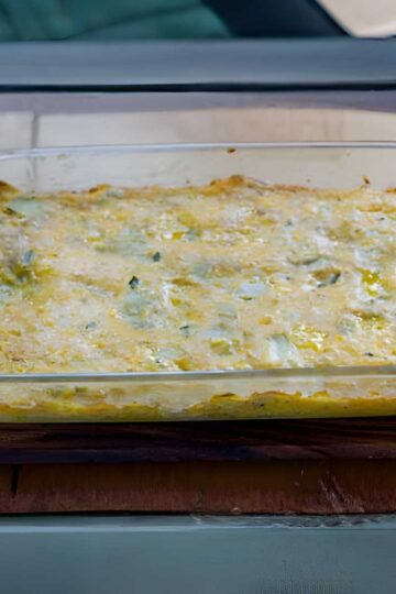 Cheesy Spinach Artichoke Squares baked in a glass dish.