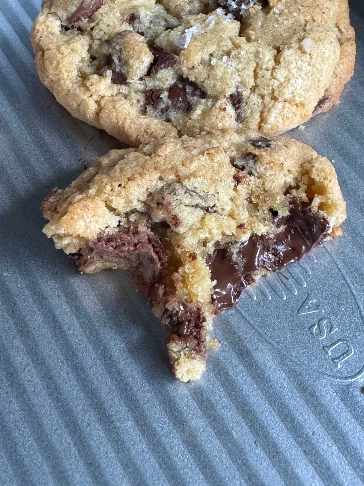 Salty Chocolate Chunk Cookies split open and showing texture of melted chocolate