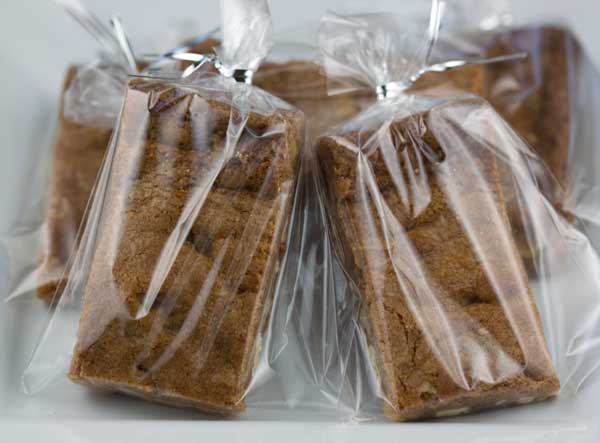 Chewy White Chocolate Macadamia Bars wrapped up for a bake sale.