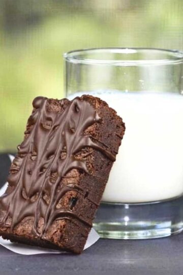 Thick fudge brownie made in one saucepan served with a glass of milk.