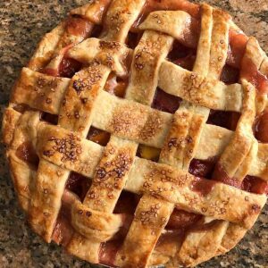 Double Crust Peach Pie recipe with fresh or frozen peaches and a lattice.