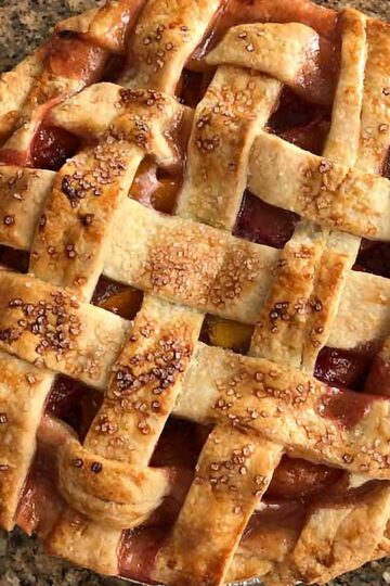 Double Crust Peach Pie recipe with fresh or frozen peaches and a lattice.