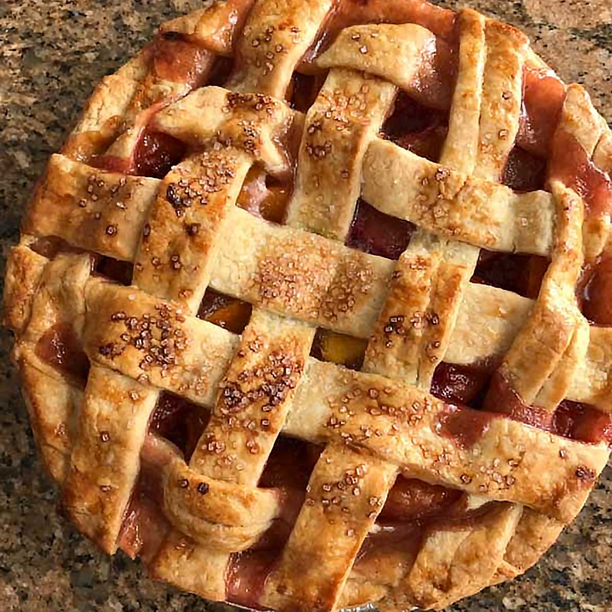 Double Crust Peach Pie recipe with fresh or frozen peaches and a lattice.