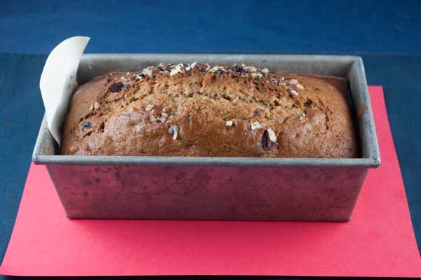 A loaf of sweet potato quick bread made with mashed sweet potatoes and baked in an 8 ½ by 4 ½ inch loaf pan.