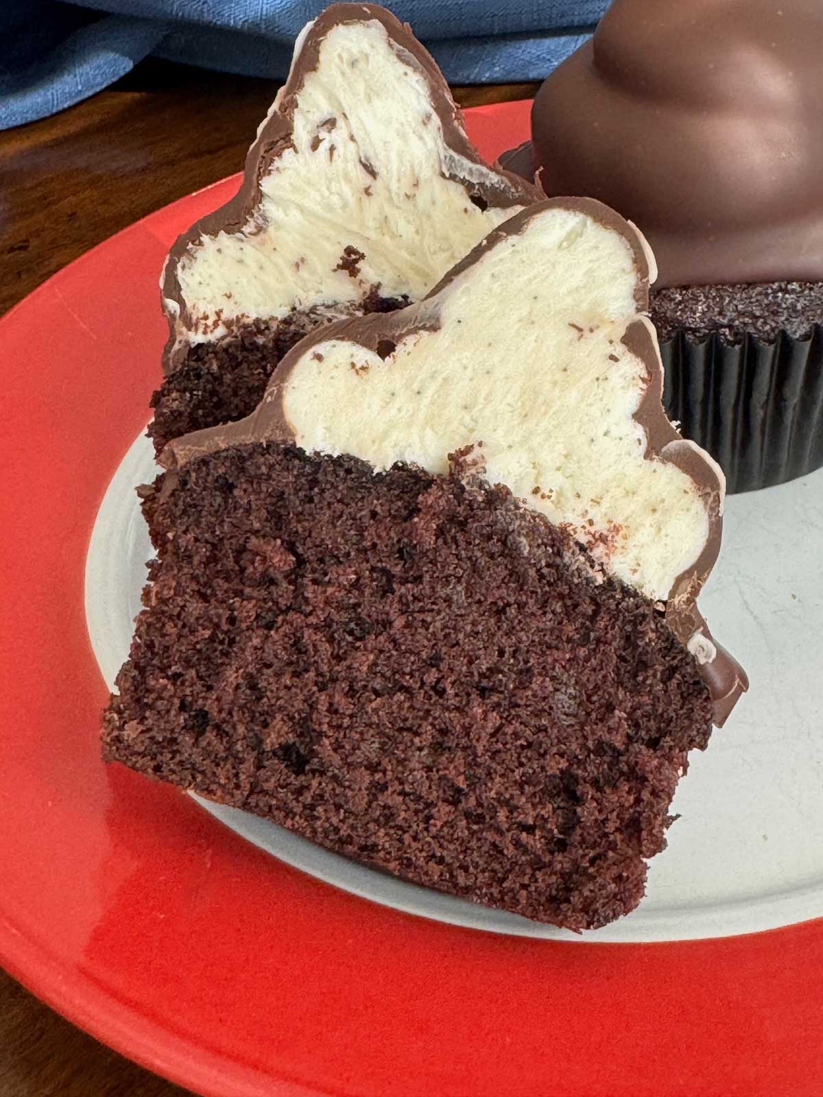 Chocolate Dipped Cupcakes split to show vanilla bean buttercream frosting.