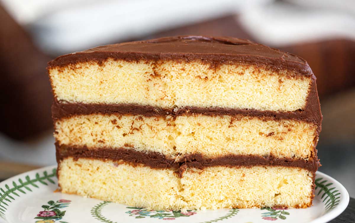 Grandbaby Cakes Cookbook Classic Yellow Cake baked as three layers.