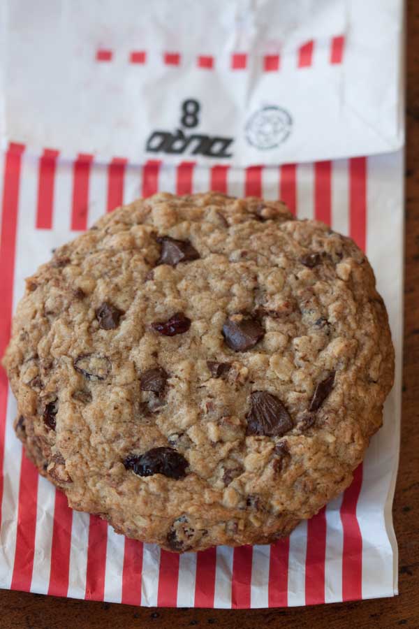 Martha Bakes Kitchen Sink Cookies with a red and white paper bag in the background.