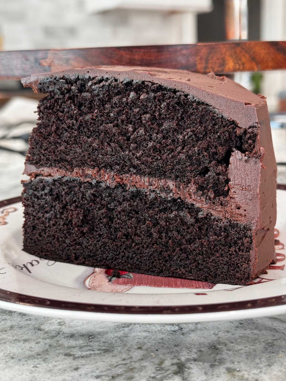 Slice of Ina Garten's Chocolate Cake with a ganache frosting.