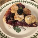 A slice of blackberry pie with buttery pastry crust.