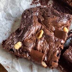 Hazelnut brownies made with oil, topped with nuts and swirled with Nutella