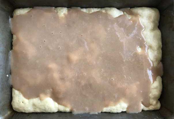 Swedish Ripple Cake being assembled showing dough with caramel topping poured over.