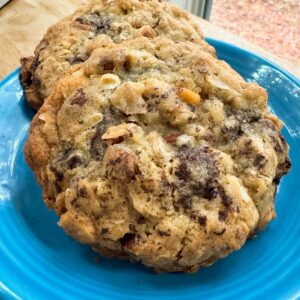 Thick Almond Chocolate Chunk Cookies on a blue plate showing nutty texture.