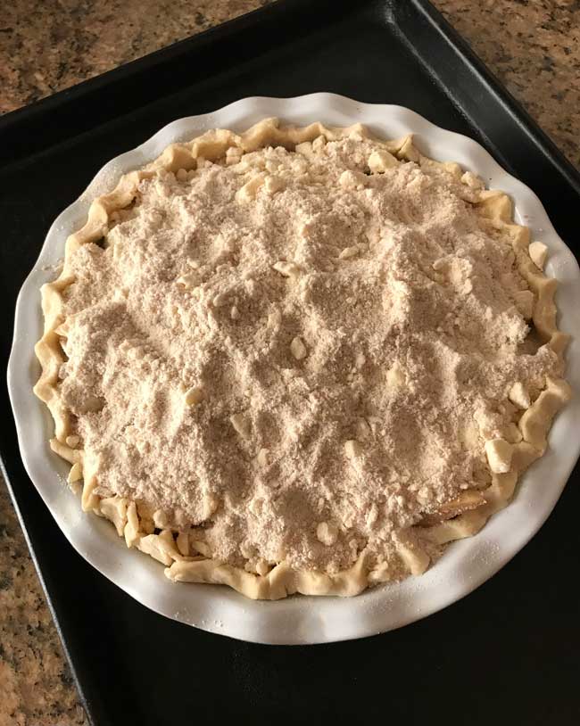 Unbaked pie with a crumb topping.