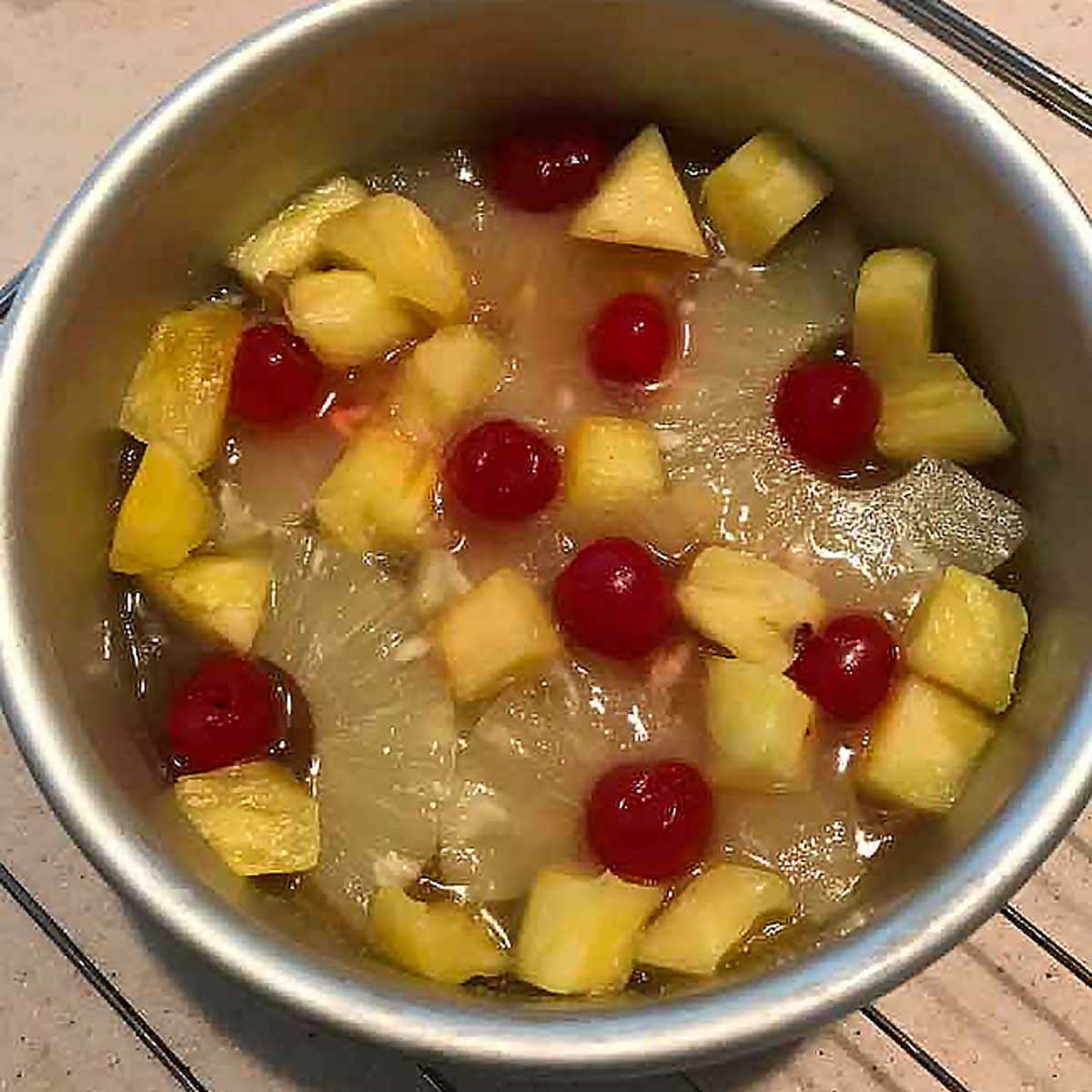 Pineapple Upside Down Cake for Two being assembled in a six inch round cake pan.