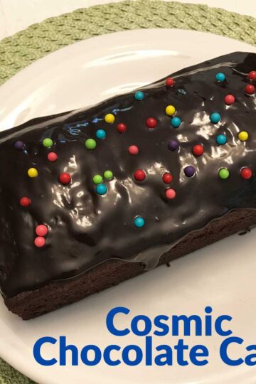 Cosmic Chocolate Cake, a brown sugar chocolate loaf cake wit h a glossy glaze and sprinkles.