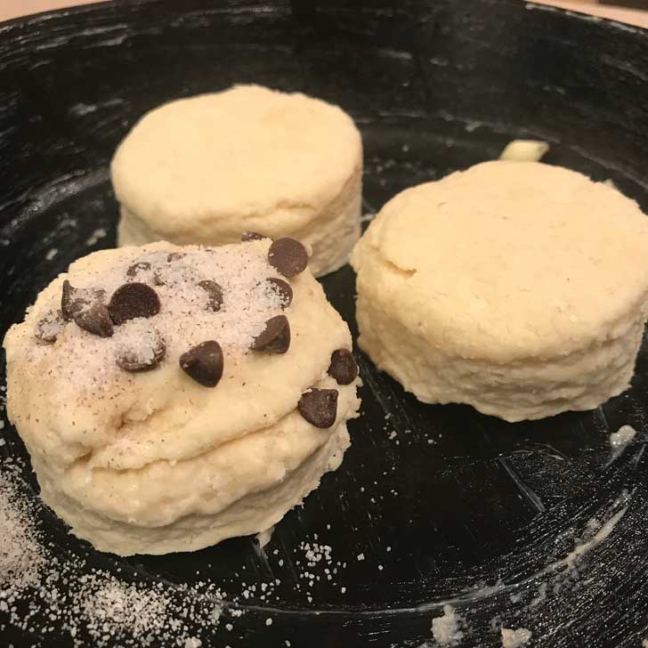 Layered Biscuits unbaked sitting in a cast iron skillet