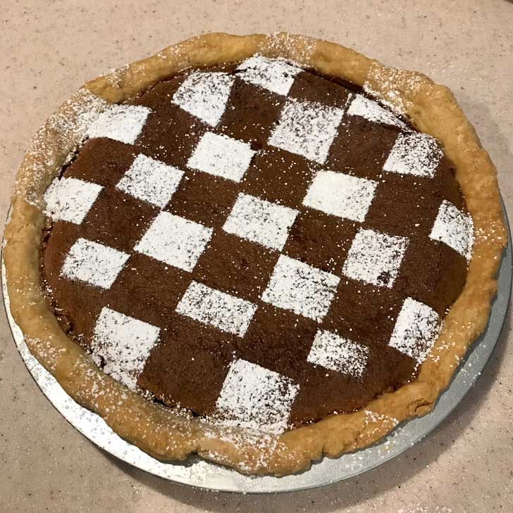 Chocolate Chess Pie with confectioners' sugar grid.